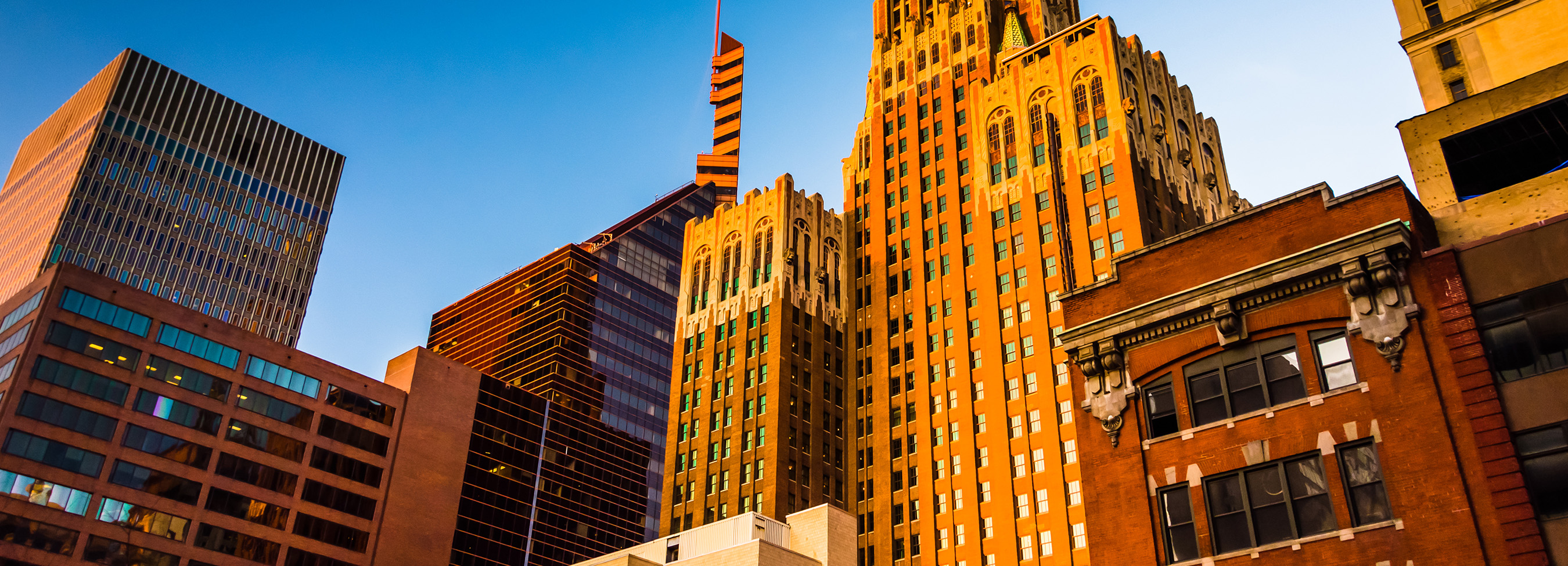 Photo looking up at skyscraper buildings